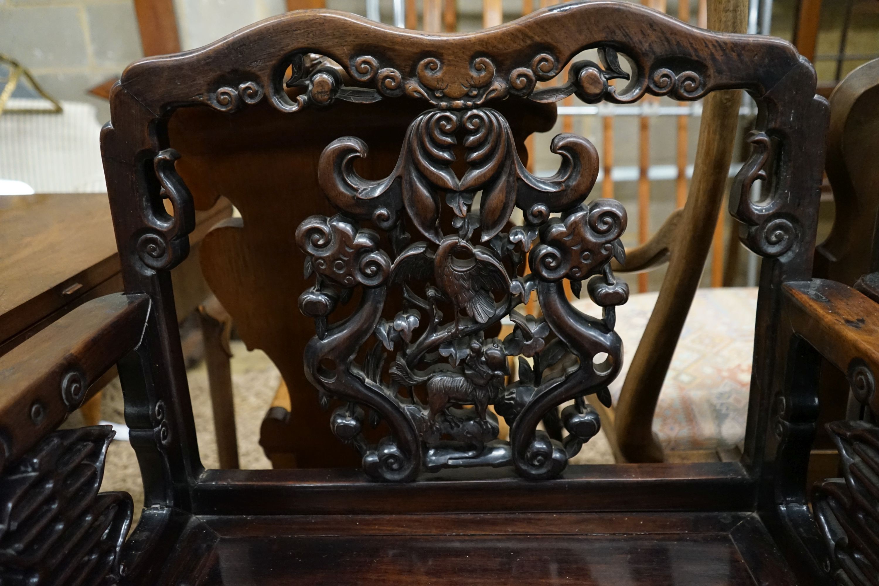 A pair of Chinese carved hongmu elbow chairs (a.f.), width 65cm, depth 48cm, height 96cm